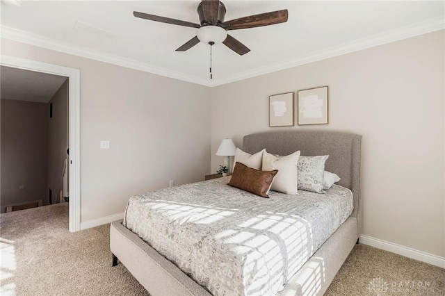 bedroom with ceiling fan, crown molding, and carpet floors