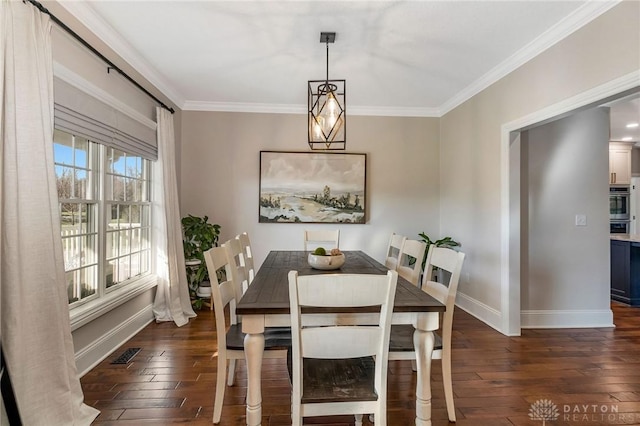 dining area featuring crown molding and dark wood-type flooring