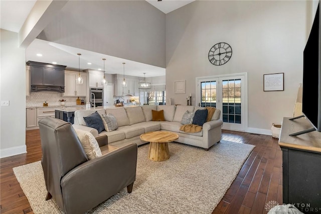 living room featuring dark hardwood / wood-style floors and a high ceiling