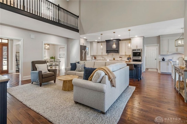 living room featuring dark hardwood / wood-style floors and a high ceiling