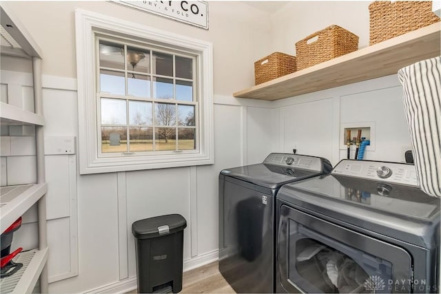 clothes washing area featuring separate washer and dryer