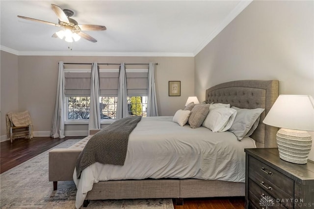 bedroom featuring dark hardwood / wood-style floors, ceiling fan, and ornamental molding