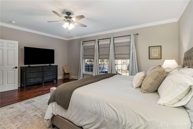 bedroom featuring ceiling fan, dark hardwood / wood-style flooring, and crown molding