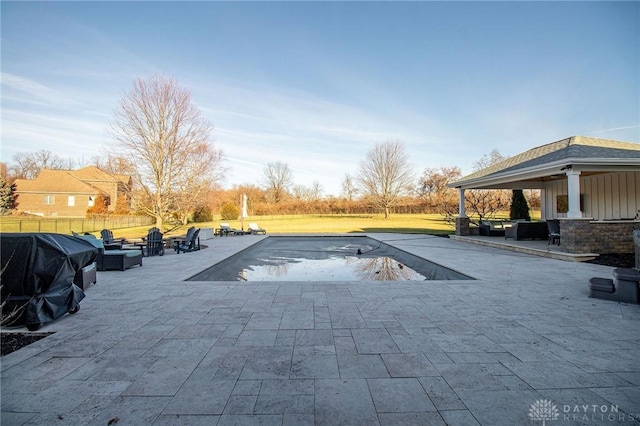 view of pool with grilling area and a patio area