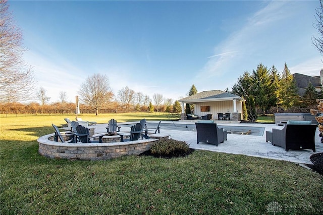 view of yard with an outdoor living space with a fire pit and a patio area