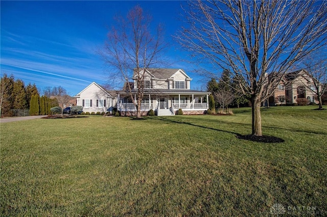 cape cod home featuring covered porch and a front lawn