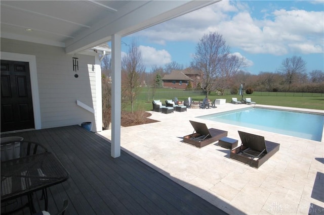 view of pool featuring an outdoor living space, a deck, and a yard