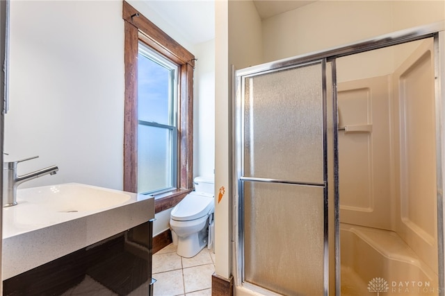 bathroom featuring sink, toilet, tile patterned flooring, and walk in shower