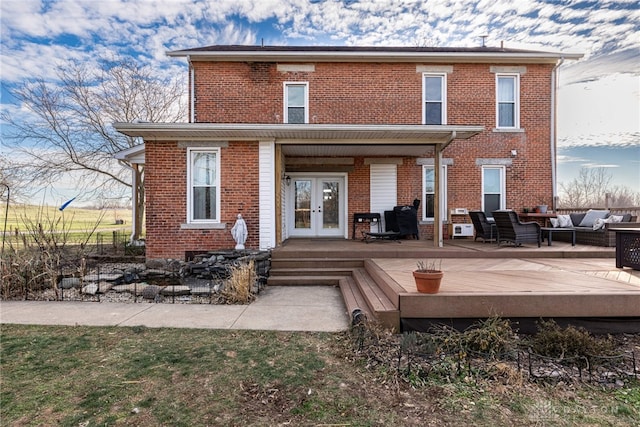 rear view of house featuring french doors, an outdoor living space, and a wooden deck