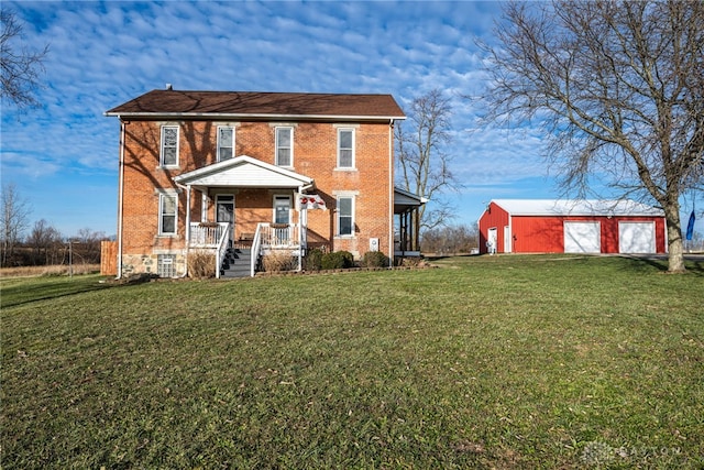 view of front of property featuring a porch, a garage, an outdoor structure, and a front yard