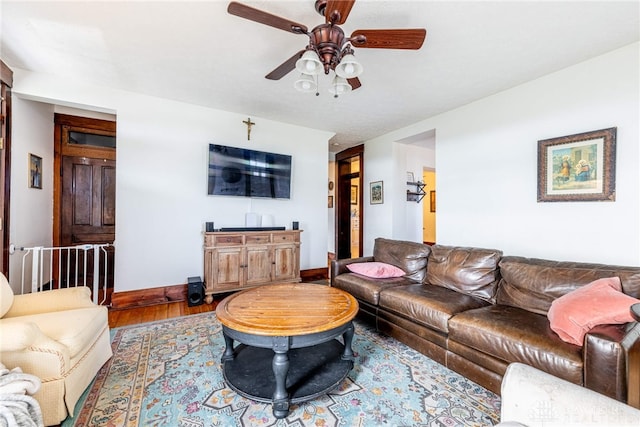 living room with ceiling fan and wood-type flooring