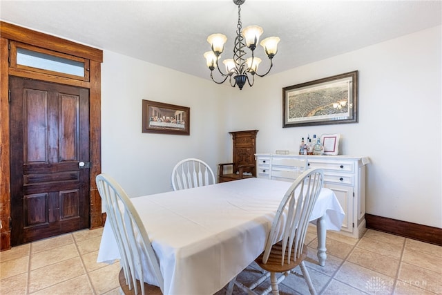 tiled dining area featuring a chandelier