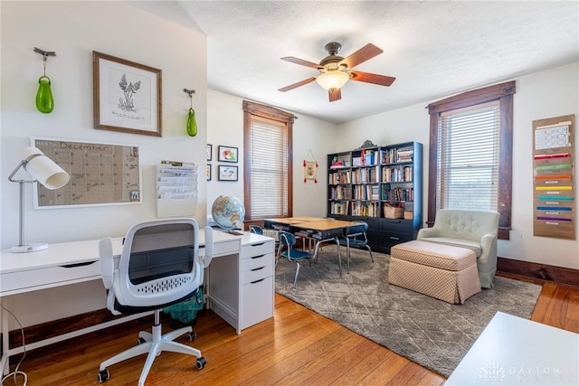 office space with ceiling fan, a textured ceiling, and hardwood / wood-style flooring