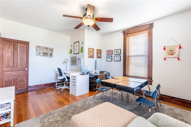 office with hardwood / wood-style flooring and ceiling fan