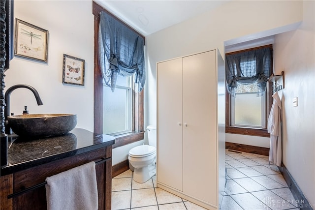 bathroom featuring toilet, vanity, and tile patterned floors