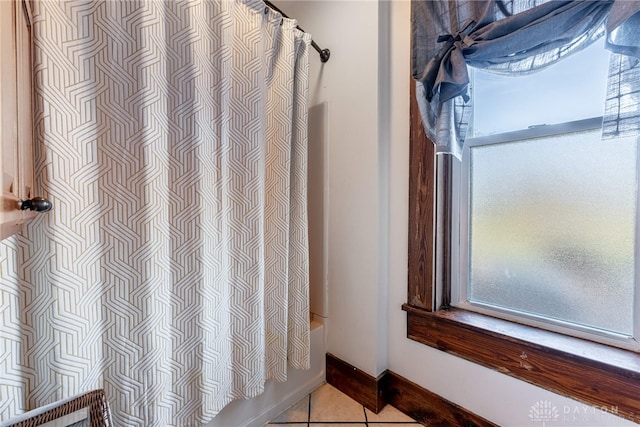 bathroom featuring tile patterned flooring and shower / tub combo