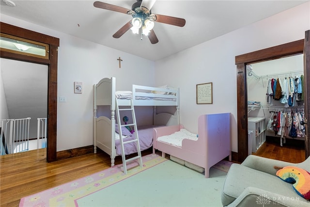 bedroom with ceiling fan, a closet, and wood-type flooring