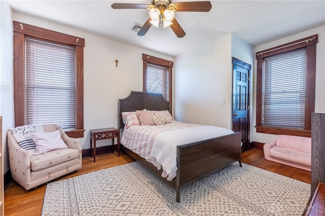 bedroom with ceiling fan and light hardwood / wood-style floors