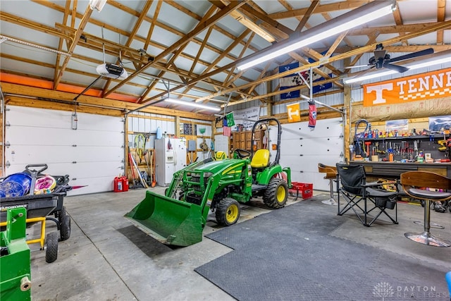 garage with a workshop area, white refrigerator with ice dispenser, and a garage door opener