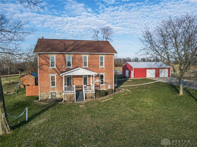 view of front of home featuring a front lawn, an outdoor structure, and a garage