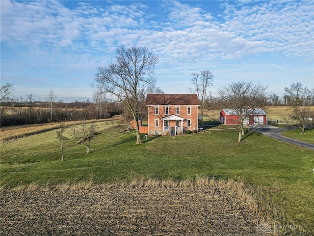 view of yard with a rural view and a garage