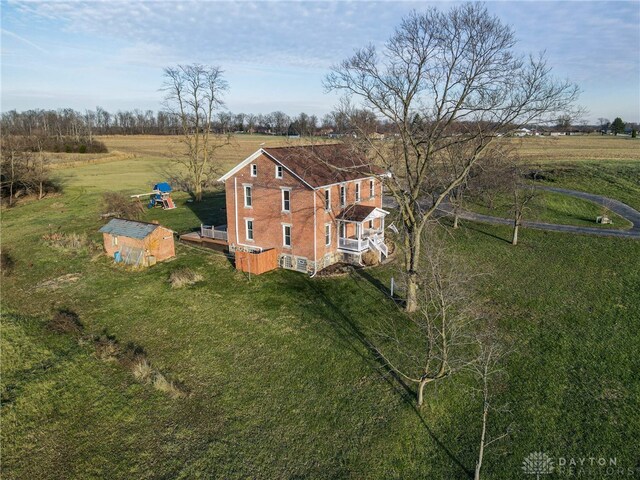 birds eye view of property with a rural view