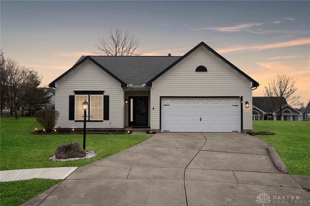 ranch-style house with a lawn and a garage