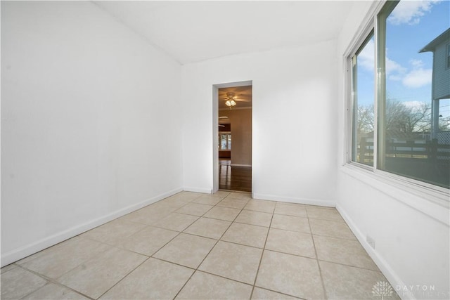 empty room featuring ceiling fan and light tile patterned floors