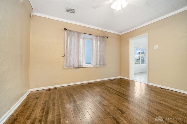 spare room with wood-type flooring and ornamental molding