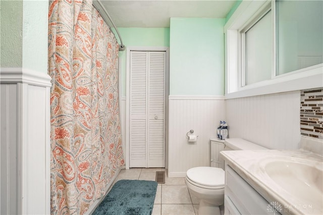 bathroom featuring tile patterned floors, vanity, and toilet