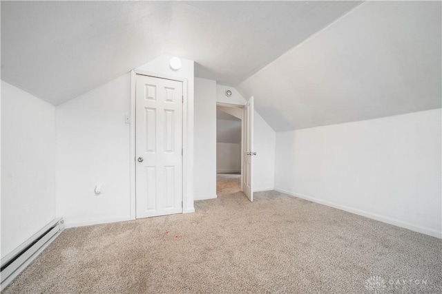 additional living space featuring carpet flooring, vaulted ceiling, and baseboard heating