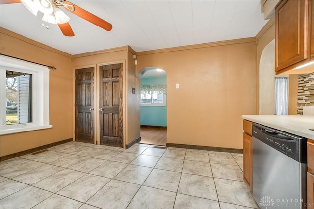 kitchen featuring dishwasher, ceiling fan, ornamental molding, light tile patterned floors, and tasteful backsplash