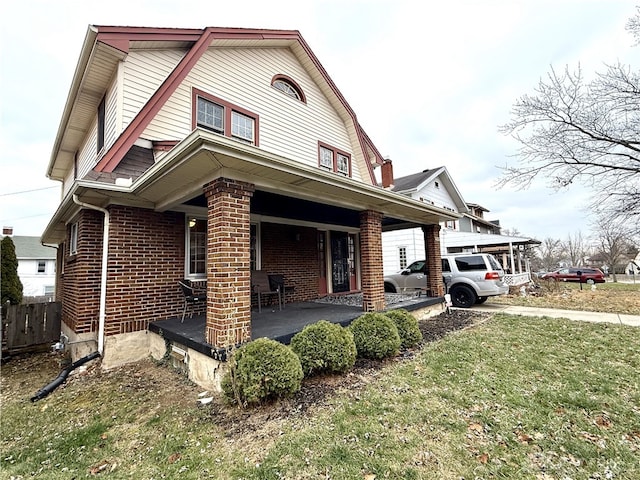 view of property exterior with a porch and a yard