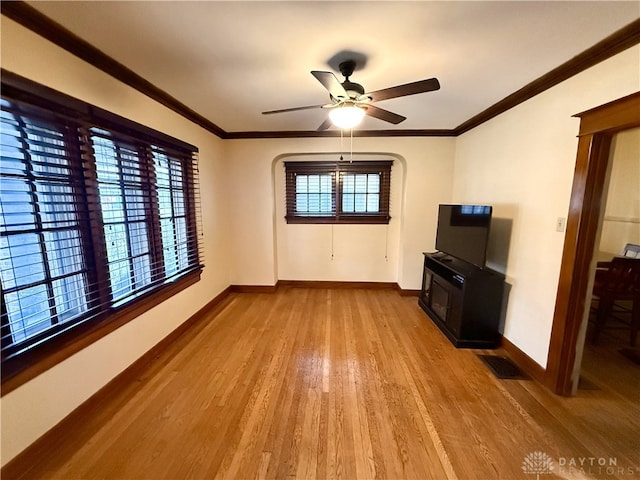 unfurnished living room featuring ceiling fan, ornamental molding, and light hardwood / wood-style flooring