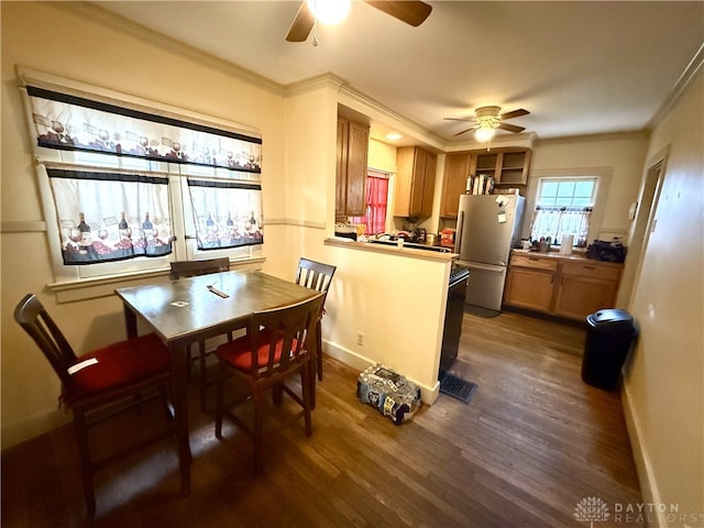 kitchen with dark hardwood / wood-style floors, white fridge, kitchen peninsula, and ceiling fan