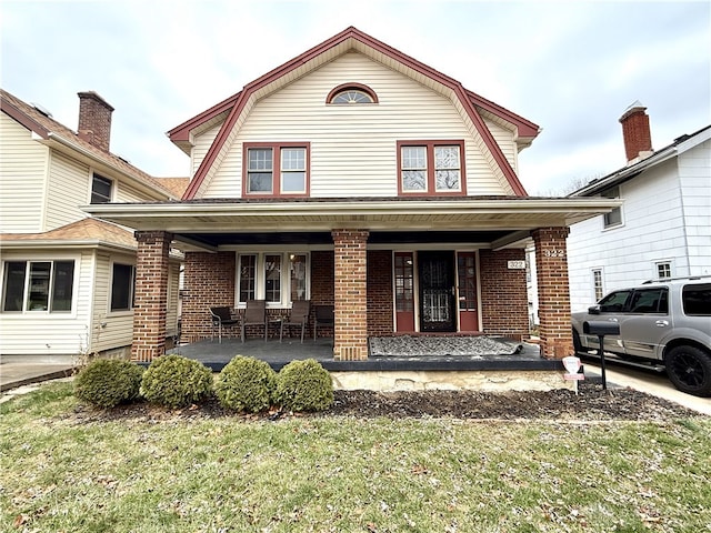 view of front property with a porch and a front yard