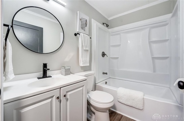 full bathroom featuring ornamental molding, vanity, hardwood / wood-style flooring, washtub / shower combination, and toilet