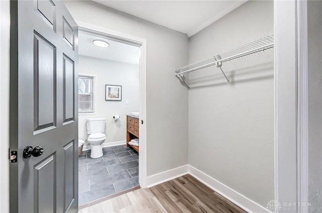 spacious closet featuring hardwood / wood-style flooring