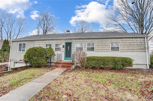 view of front of property with a garage and a front yard