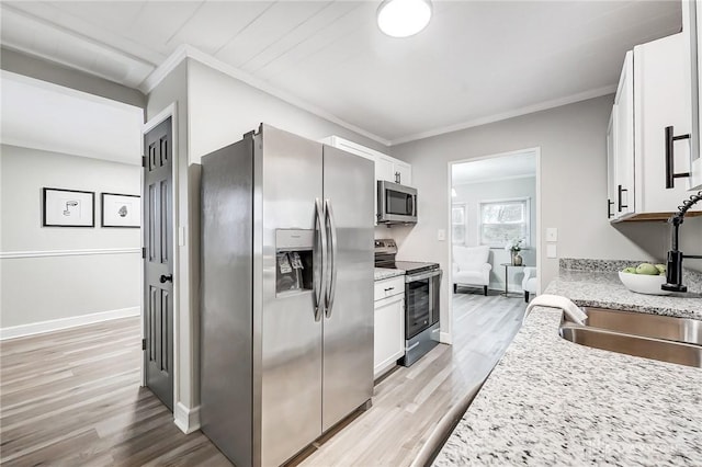 kitchen with white cabinetry, sink, and stainless steel appliances