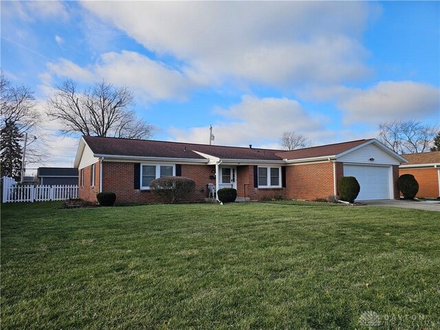 ranch-style home with a front lawn and a garage