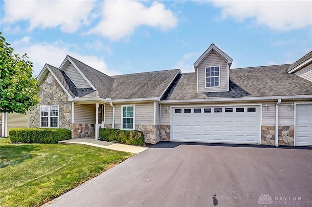 view of front of property featuring a garage and a front lawn