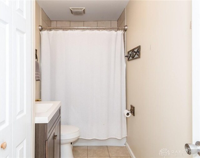 full bathroom featuring tile patterned floors, vanity, shower / bath combo, and toilet