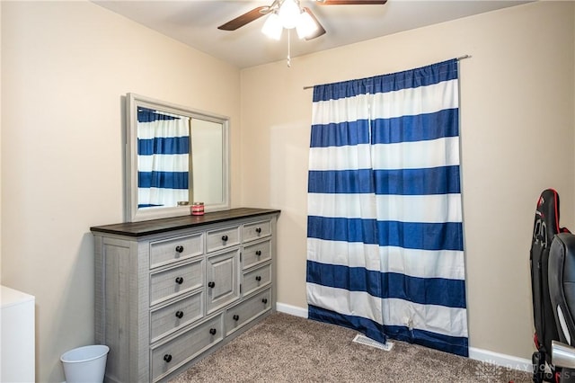 unfurnished bedroom with ceiling fan, baseboards, and carpet flooring