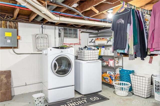 clothes washing area featuring independent washer and dryer and electric panel