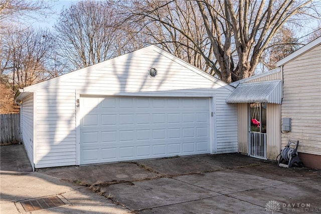 detached garage featuring fence