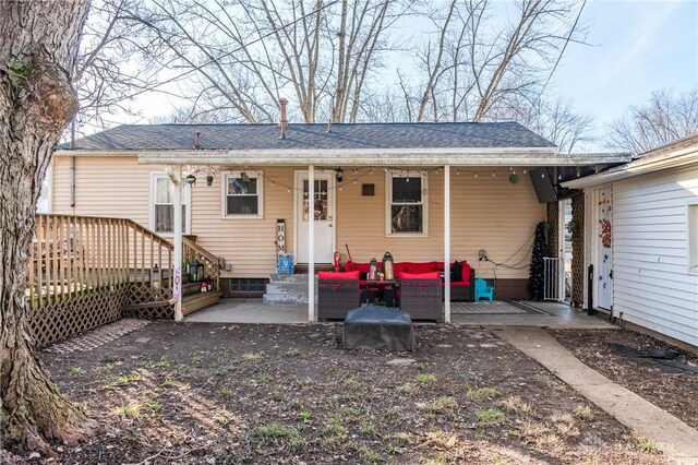 back of property featuring an outdoor living space and a patio