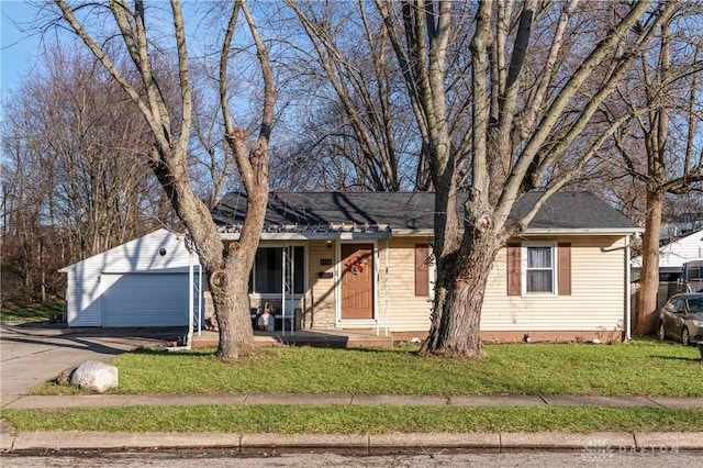 ranch-style home featuring a garage, driveway, and a front lawn