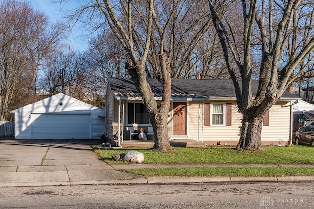 view of front of property featuring a garage, a front lawn, and an outdoor structure