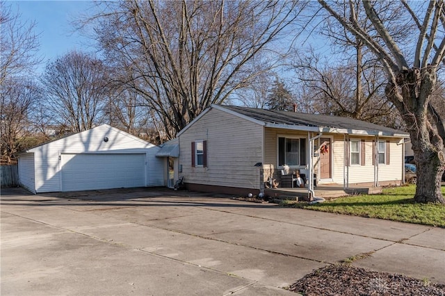 view of front of property featuring a porch, an outdoor structure, and a garage